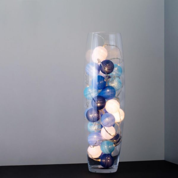 A wild atlantic way themed LED cherry light in a clear glass vase.