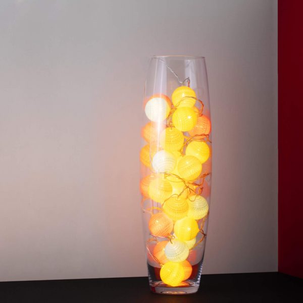 An autumn colour themed LED cherry light in a clear glass vase.