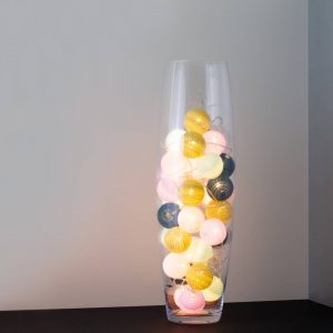 A lakeside themed LED cherry light in a clear glass vase.